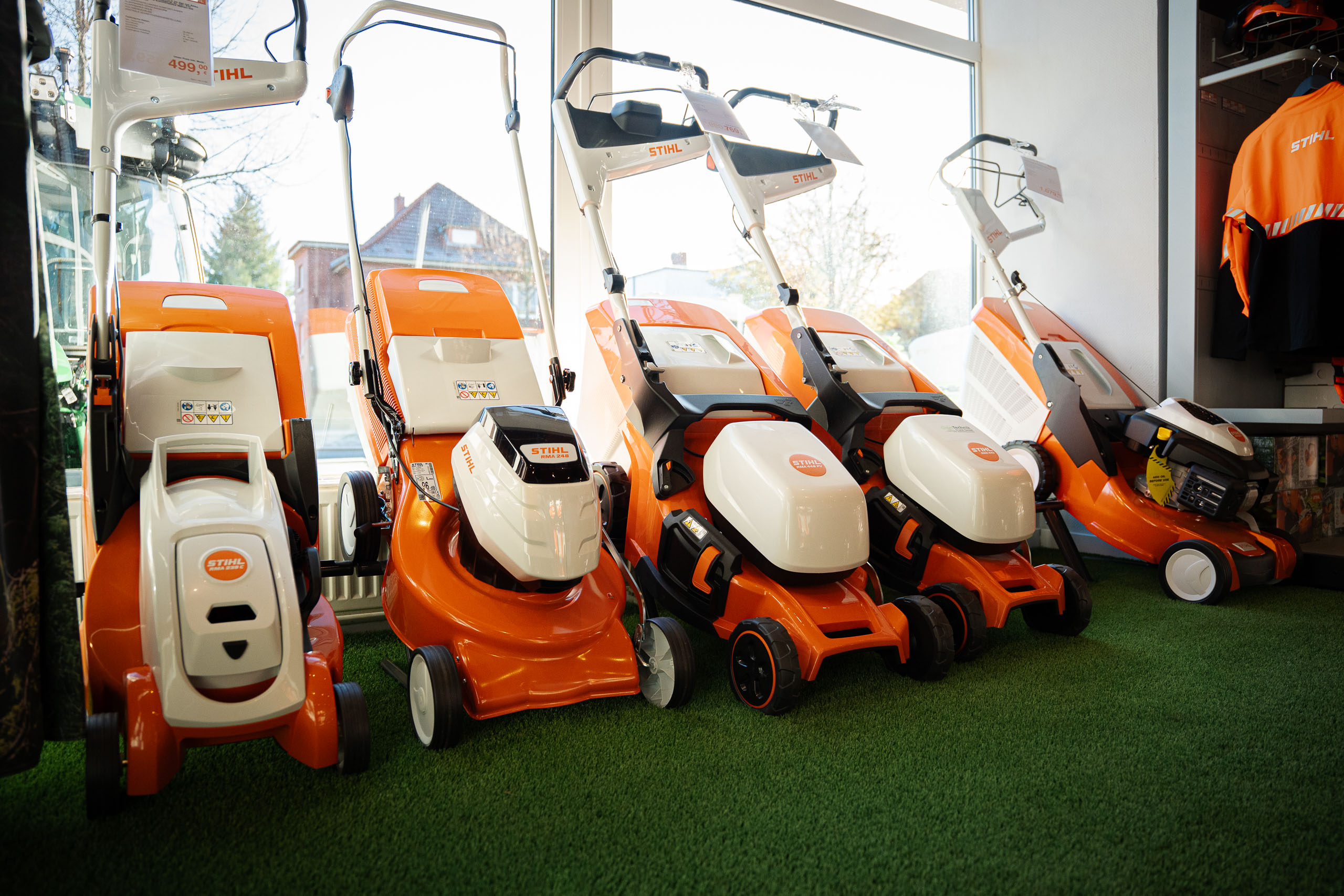 STIHL Rasenmäher-Reihe in orange-weiß in Ausstellung GrünTechnik Frank Schwerin